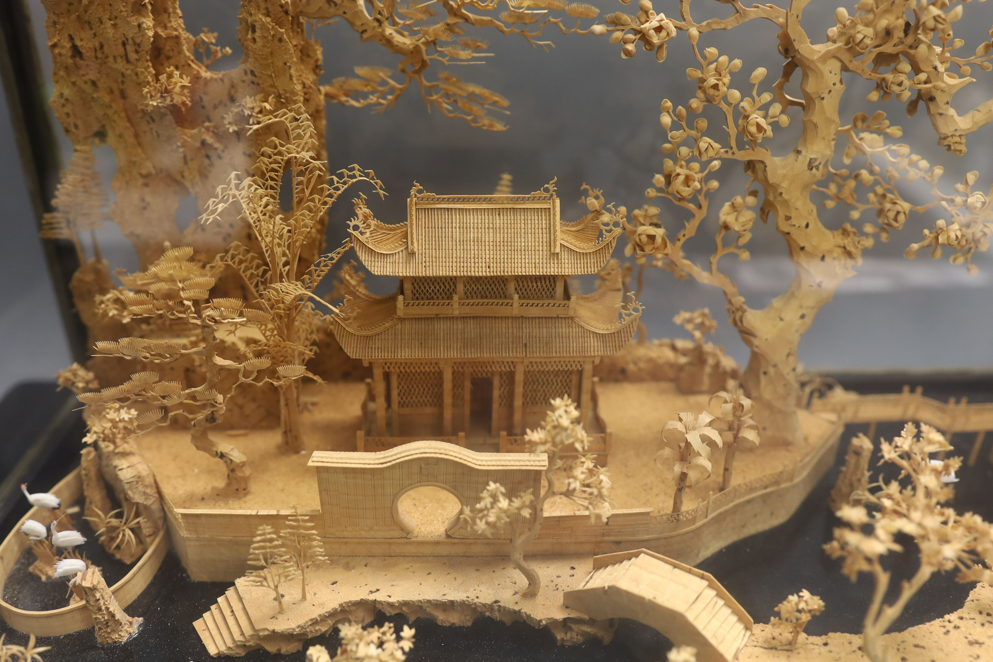 A large Chinese export Ruanmu Hua carved cork diorama, depicting a pagoda on stand - 35.5cm tall including case